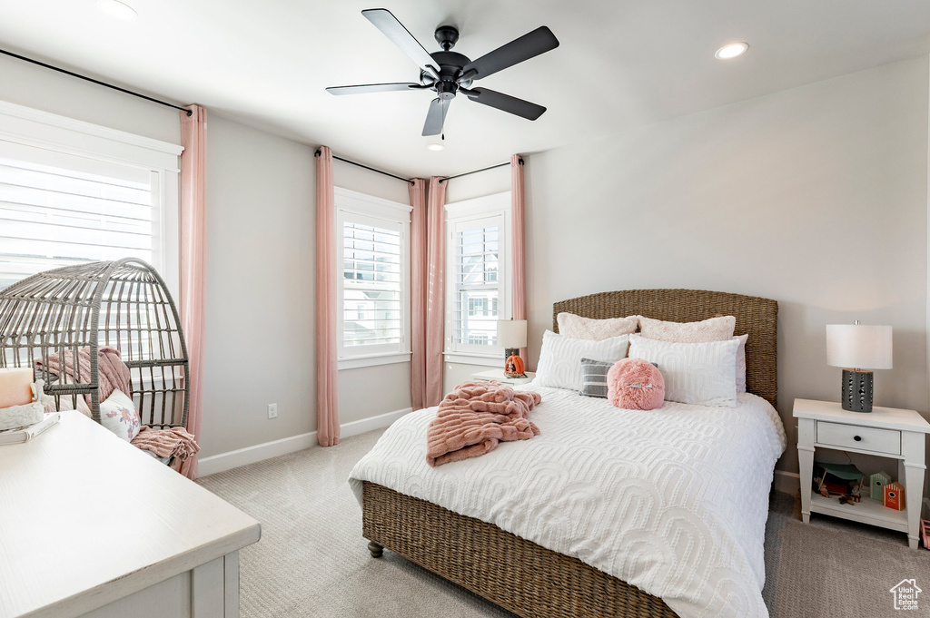 Bedroom featuring light colored carpet, baseboards, recessed lighting, and a ceiling fan