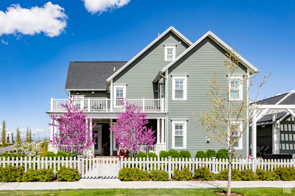 View of front facade featuring a fenced front yard and covered porch