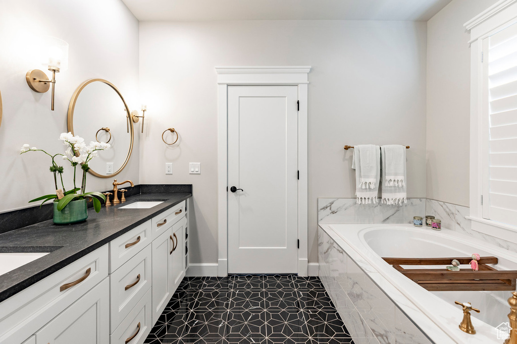 Full bathroom featuring a garden tub and double vanity