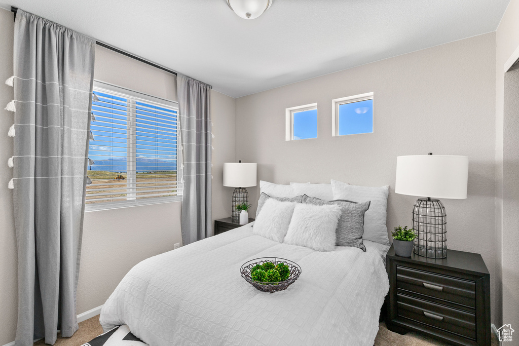 Bedroom featuring carpet floors and baseboards