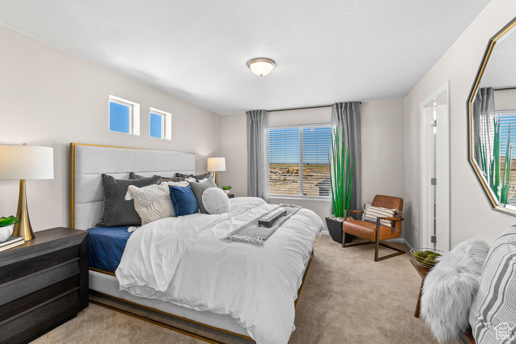 Bedroom featuring light colored carpet