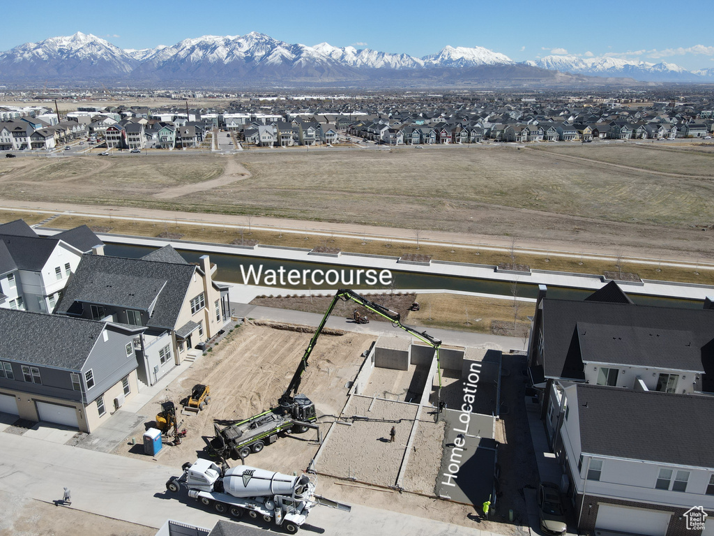 Aerial perspective of suburban area with a mountainous background