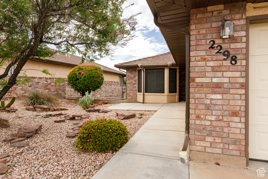 Property entrance with brick siding and fence
