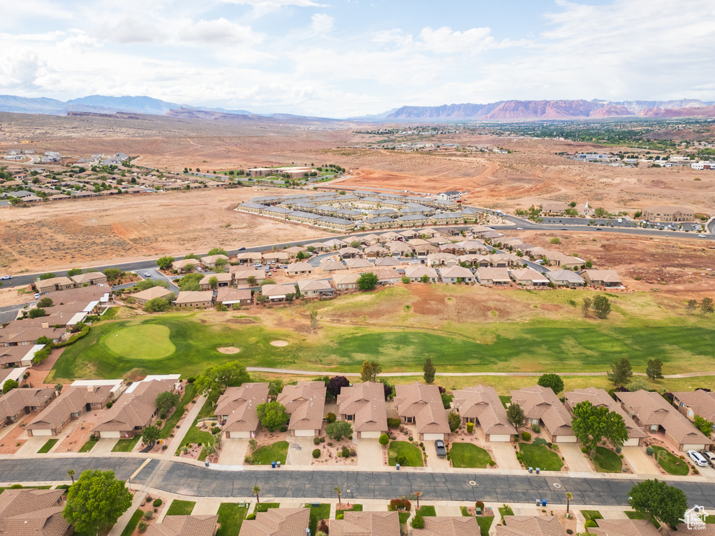 Aerial view of property's location featuring nearby suburban area and mountains