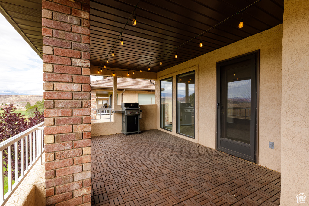 View of patio / terrace with area for grilling, a balcony, and exterior kitchen