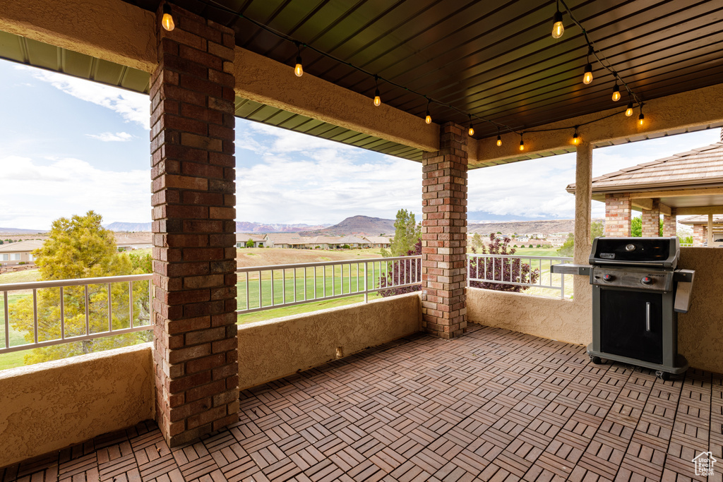 View of patio with grilling area and a mountain view