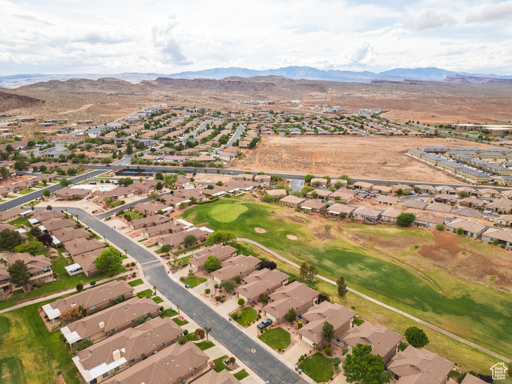 Aerial overview of property's location with nearby suburban area and a mountain backdrop