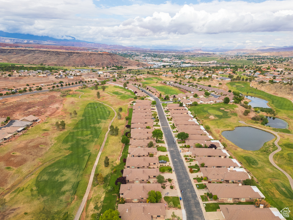 Aerial overview of property's location featuring nearby suburban area, a water and mountain view, and a golf club