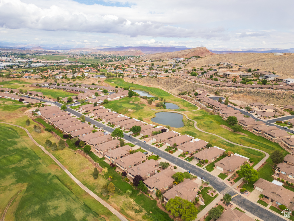 Aerial overview of property's location with a water and mountain view and nearby suburban area