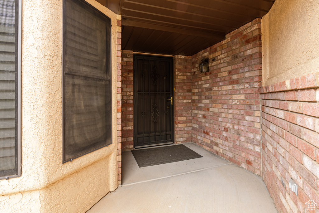 View of exterior entry with brick siding