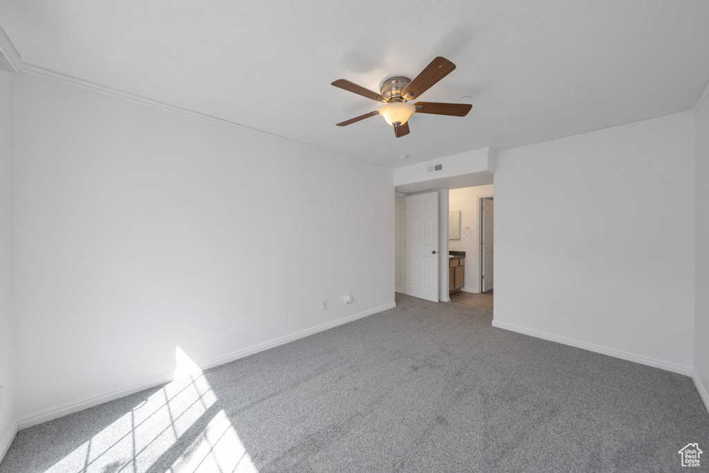 Unfurnished bedroom featuring carpet floors, visible vents, a ceiling fan, and baseboards