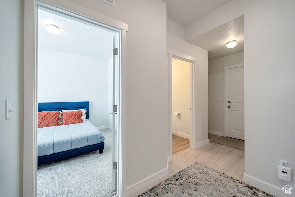 Hallway featuring wood finished floors and baseboards
