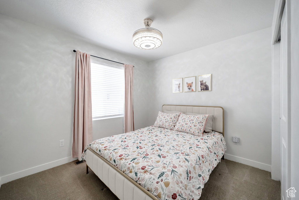 Bedroom featuring carpet floors and baseboards