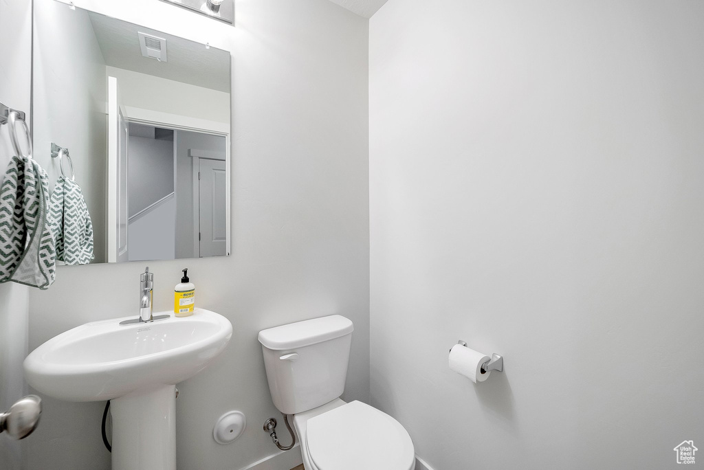 Bathroom featuring toilet and baseboards