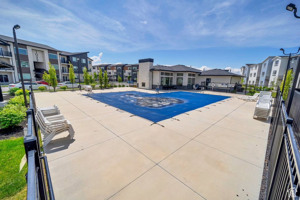 View of pool featuring a residential view and fence