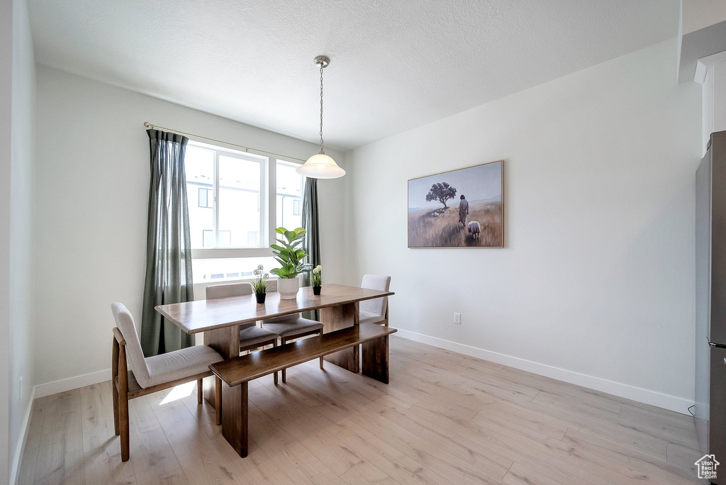 Dining space with baseboards and light wood-type flooring
