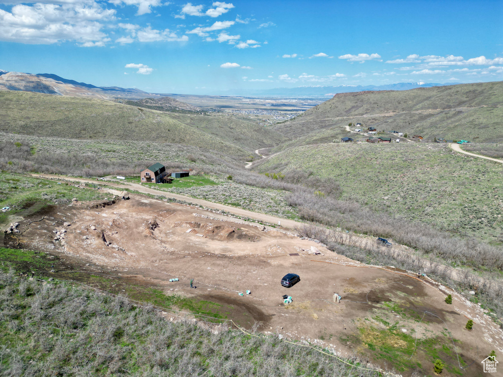 Aerial overview of property\'s location featuring a mountainous background