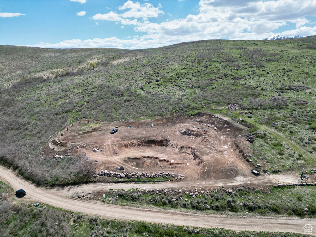 Aerial view of property and surrounding area featuring a mountain backdrop
