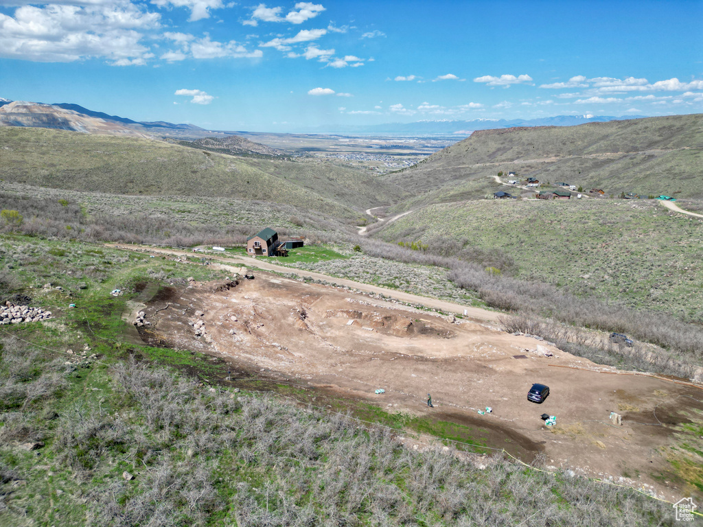 Aerial view of property and surrounding area with mountains