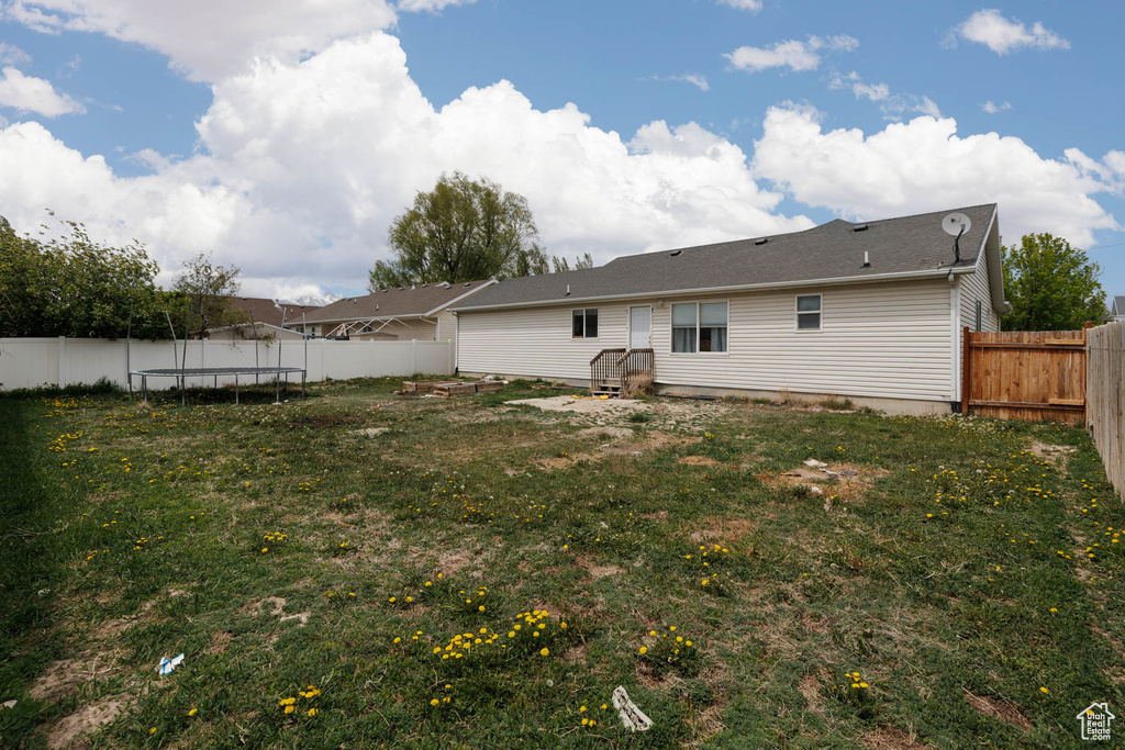 Rear view of house with a trampoline