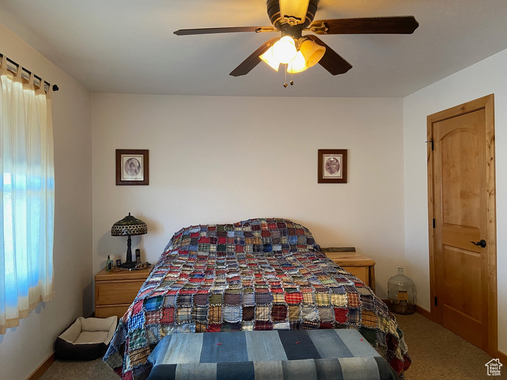 Bedroom featuring carpet flooring, a ceiling fan, and baseboards