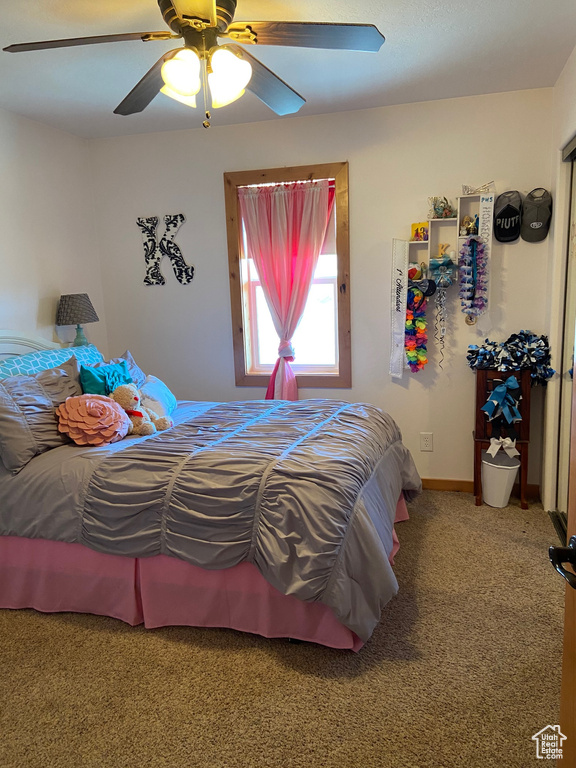 Bedroom featuring carpet flooring, a ceiling fan, and baseboards