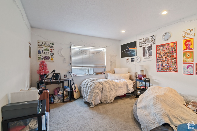Carpeted bedroom with recessed lighting