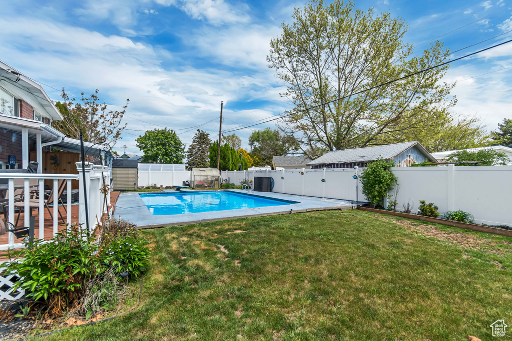 View of swimming pool featuring a storage unit and an outdoor structure