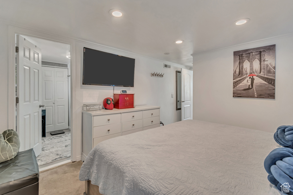Bedroom featuring crown molding, recessed lighting, and light carpet