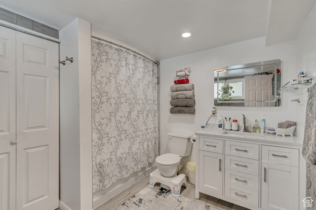 Bathroom featuring vanity, toilet, and recessed lighting
