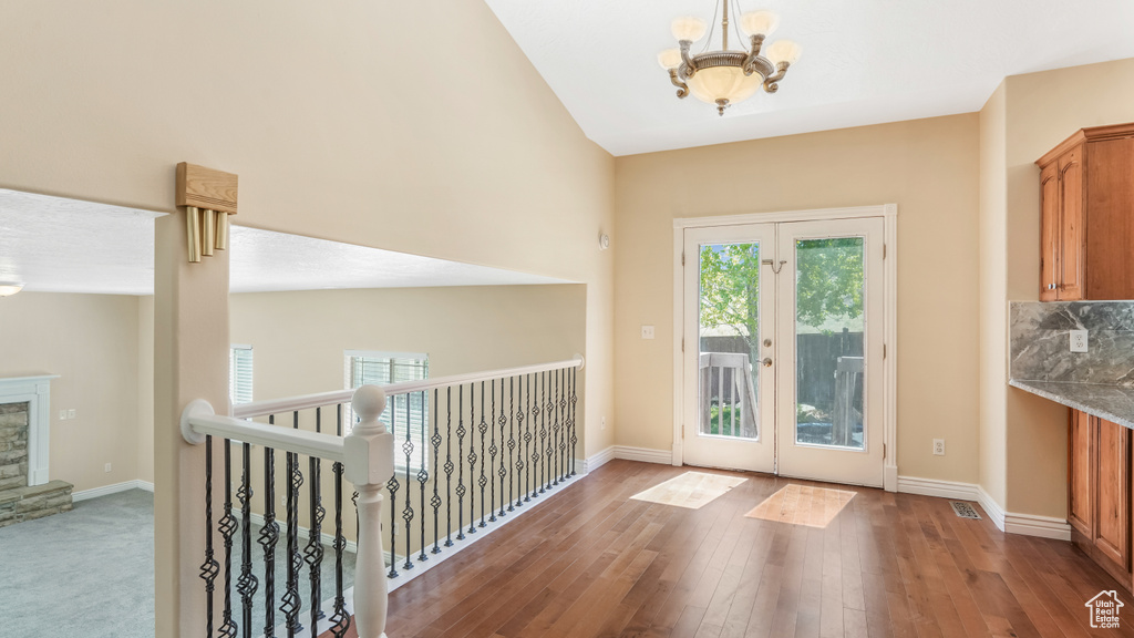 Entryway with a chandelier, french doors, baseboards, and wood-type flooring