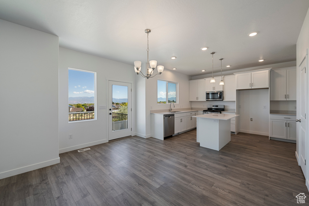 Kitchen featuring stainless steel appliances, a sink, dark wood-style floors, light countertops, and recessed lighting