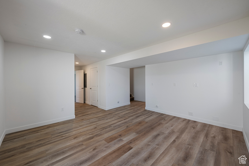 Finished basement with wood finished floors, recessed lighting, and baseboards