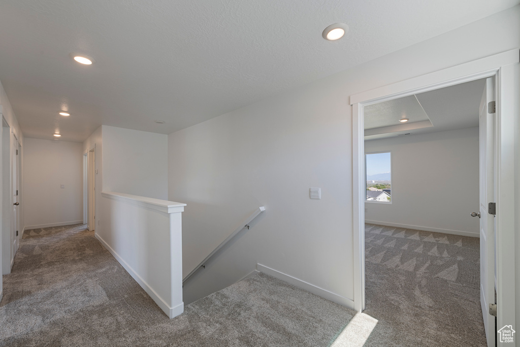 Hall featuring an upstairs landing, carpet, recessed lighting, and baseboards