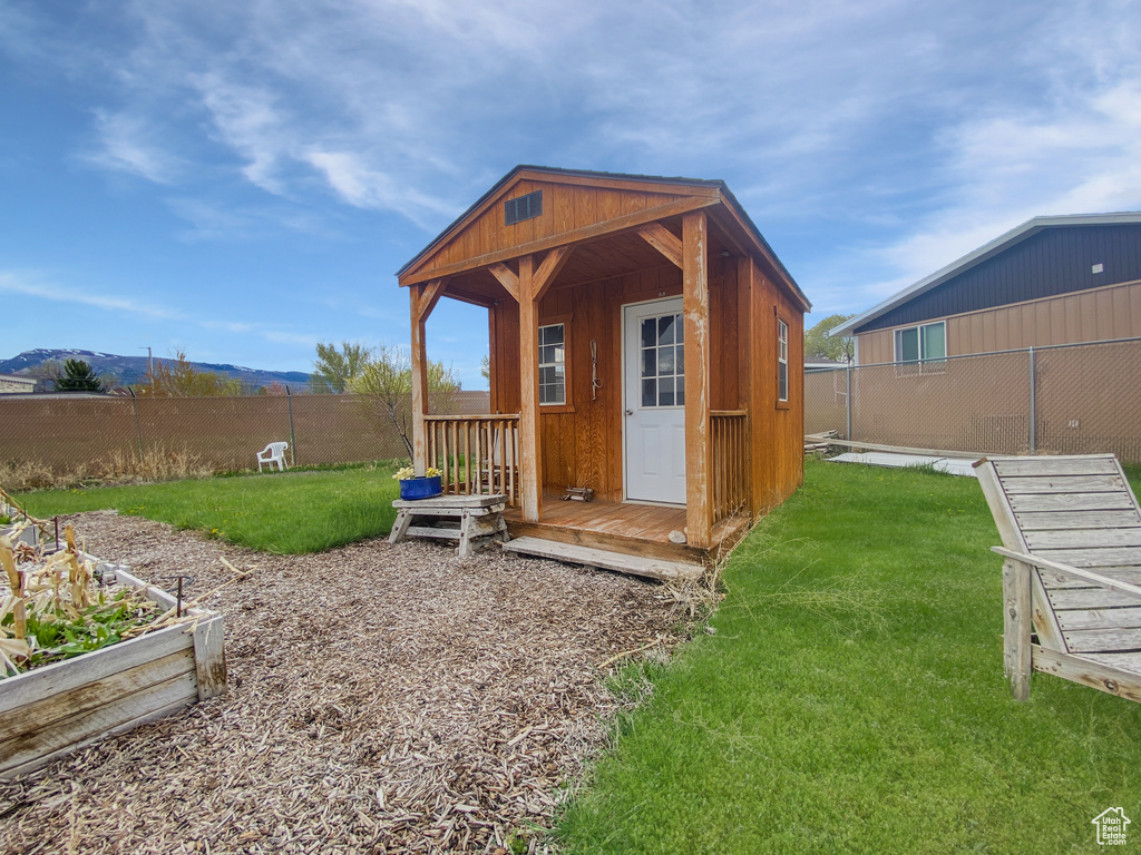View of outdoor structure with an outdoor structure, a garden, and a mountain view