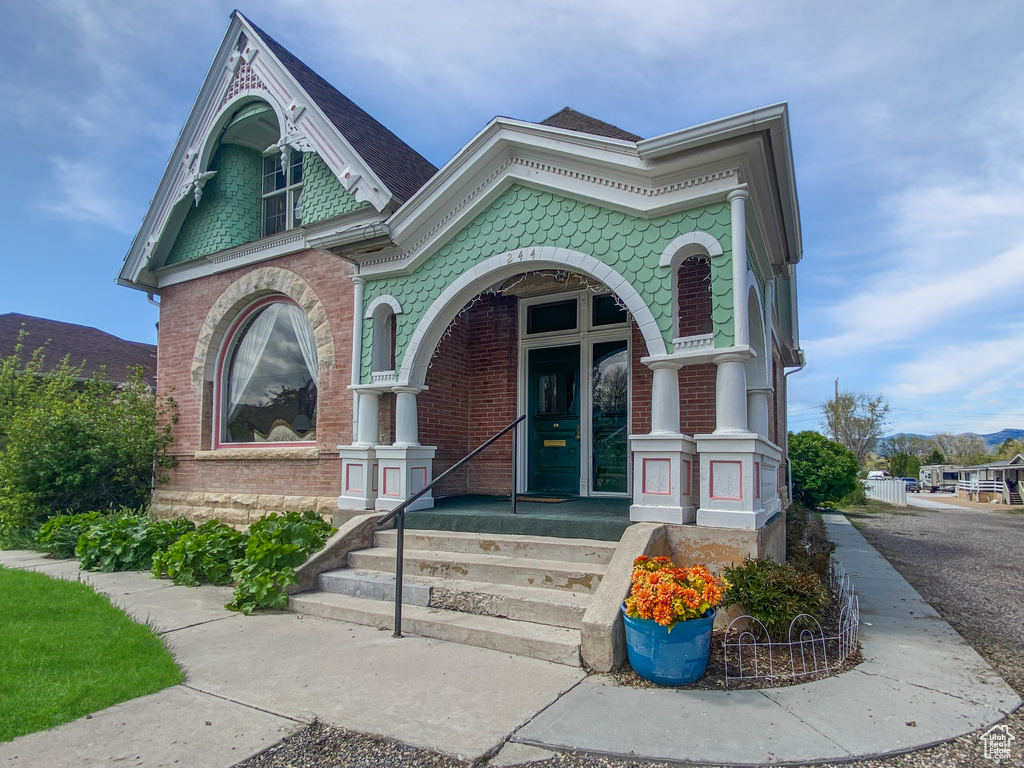 View of front of home featuring brick siding and a mountain view