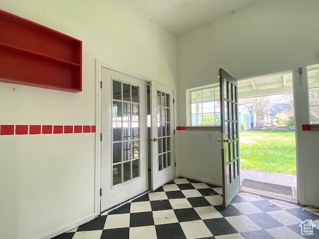 Entryway with tile patterned floors and french doors