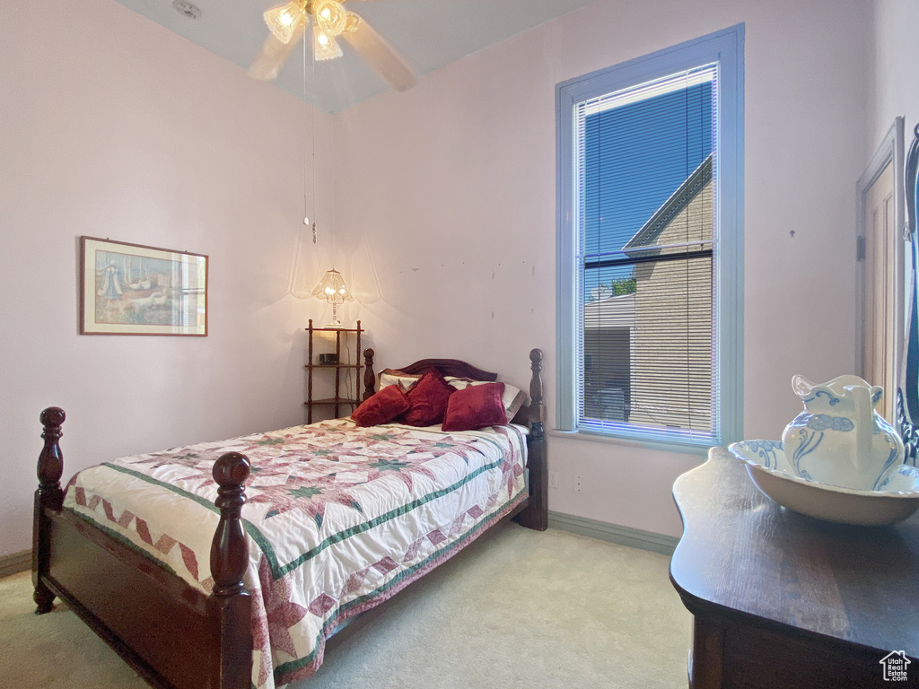 Bedroom featuring carpet and baseboards