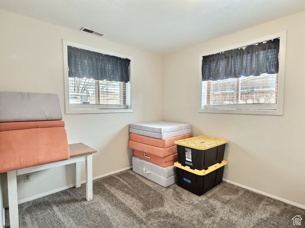 Bedroom featuring carpet and baseboards