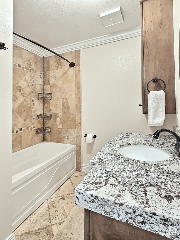 Full bathroom featuring ornamental molding,  shower combination, a textured ceiling, and vanity