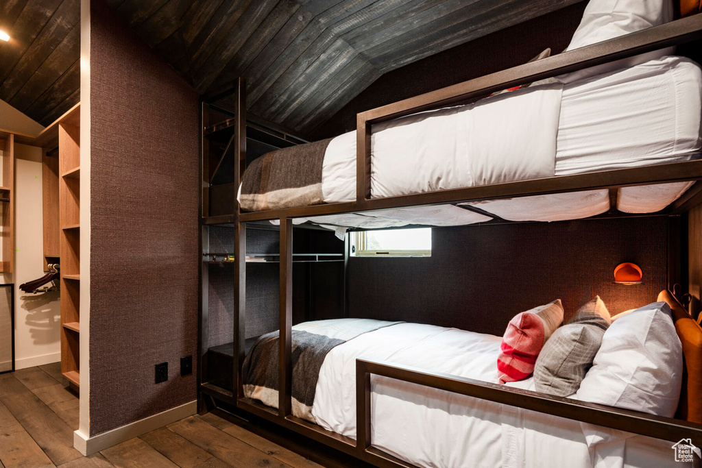 Bedroom featuring vaulted ceiling, wood-type flooring, and wood ceiling