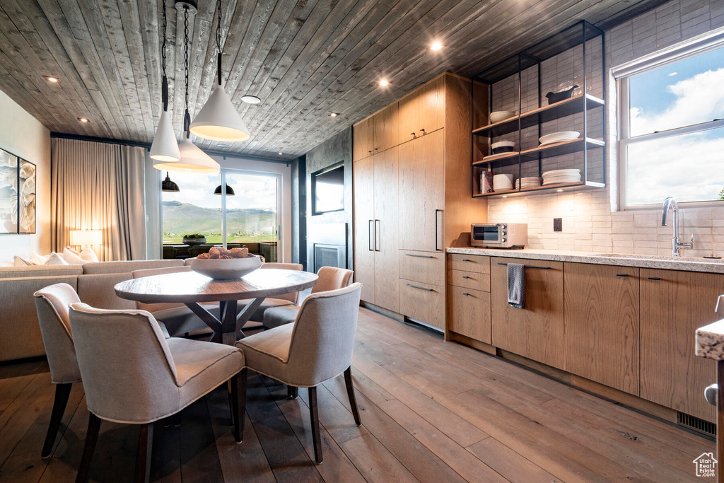 Dining area with light wood-style floors, recessed lighting, and wood ceiling