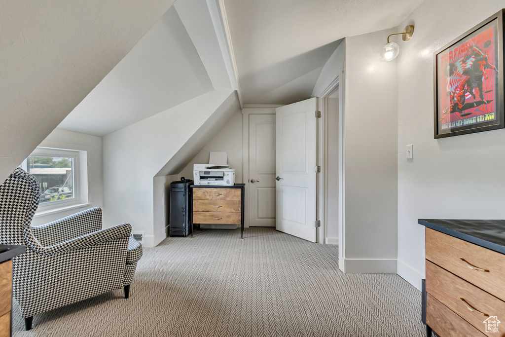Sitting room with light colored carpet and baseboards