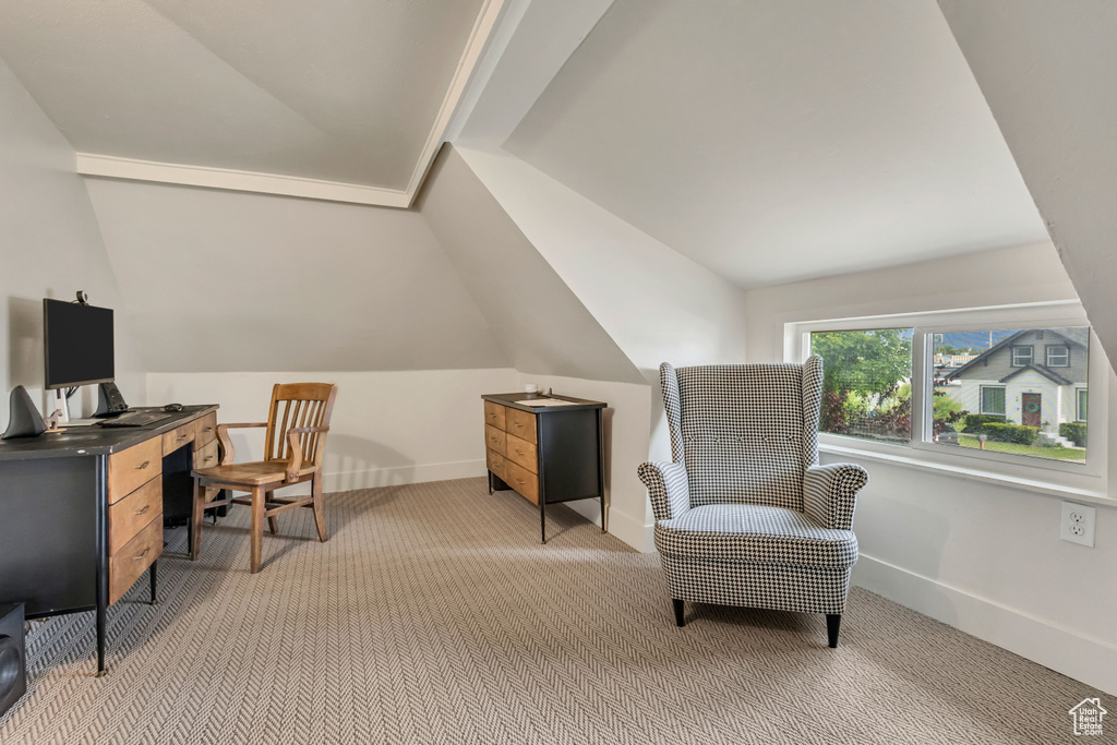 Office space with lofted ceiling, light carpet, and baseboards