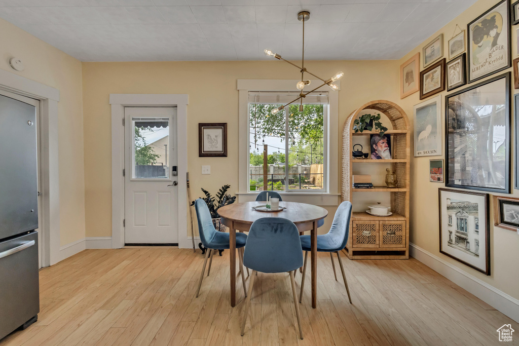 Dining area featuring plenty of natural light, light wood-style flooring, and baseboards