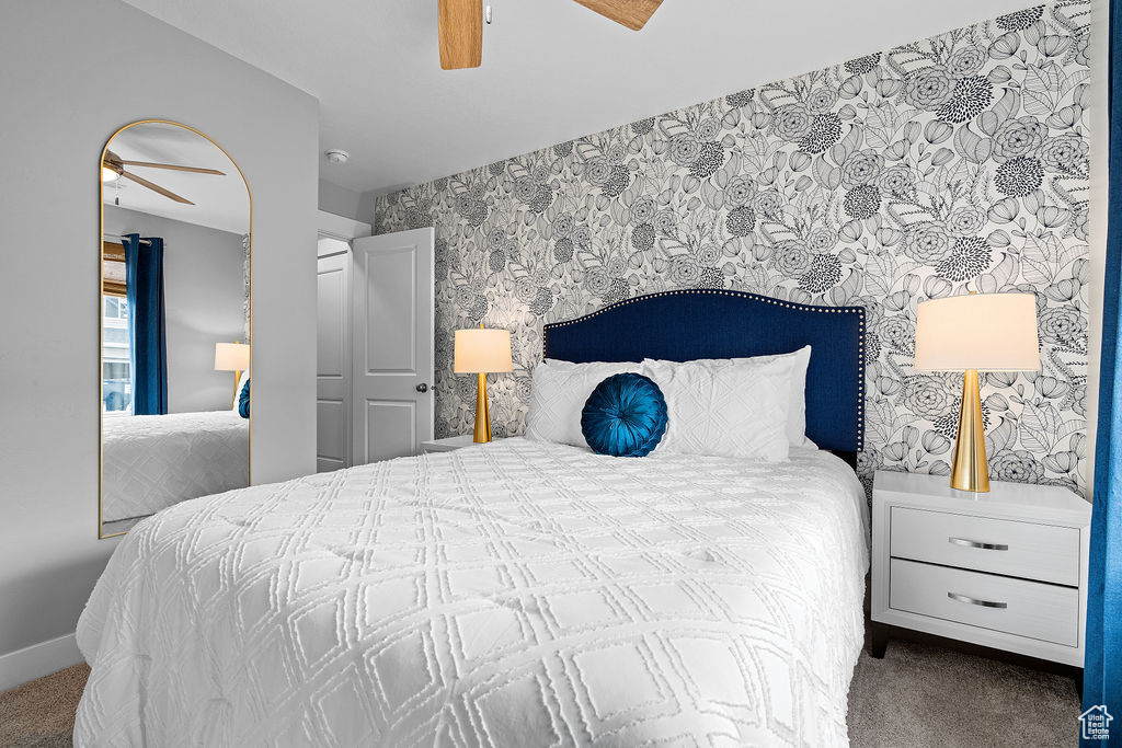 Bedroom featuring wallpapered walls, carpet floors, ceiling fan, and baseboards