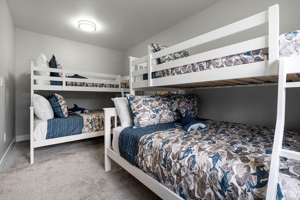 Bedroom with carpet flooring and baseboards
