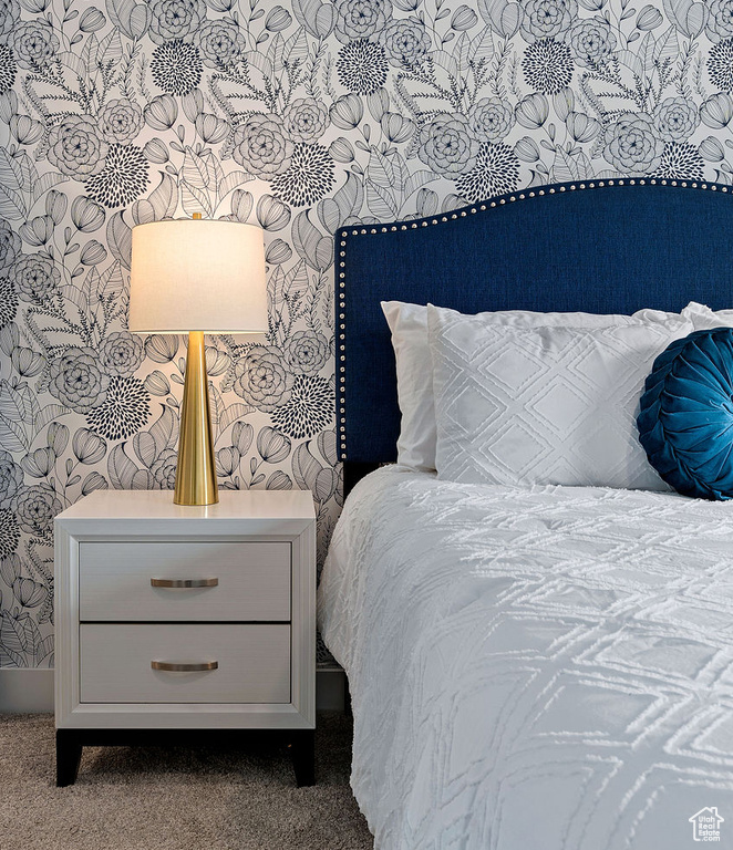 Bedroom featuring carpet flooring and wallpapered walls