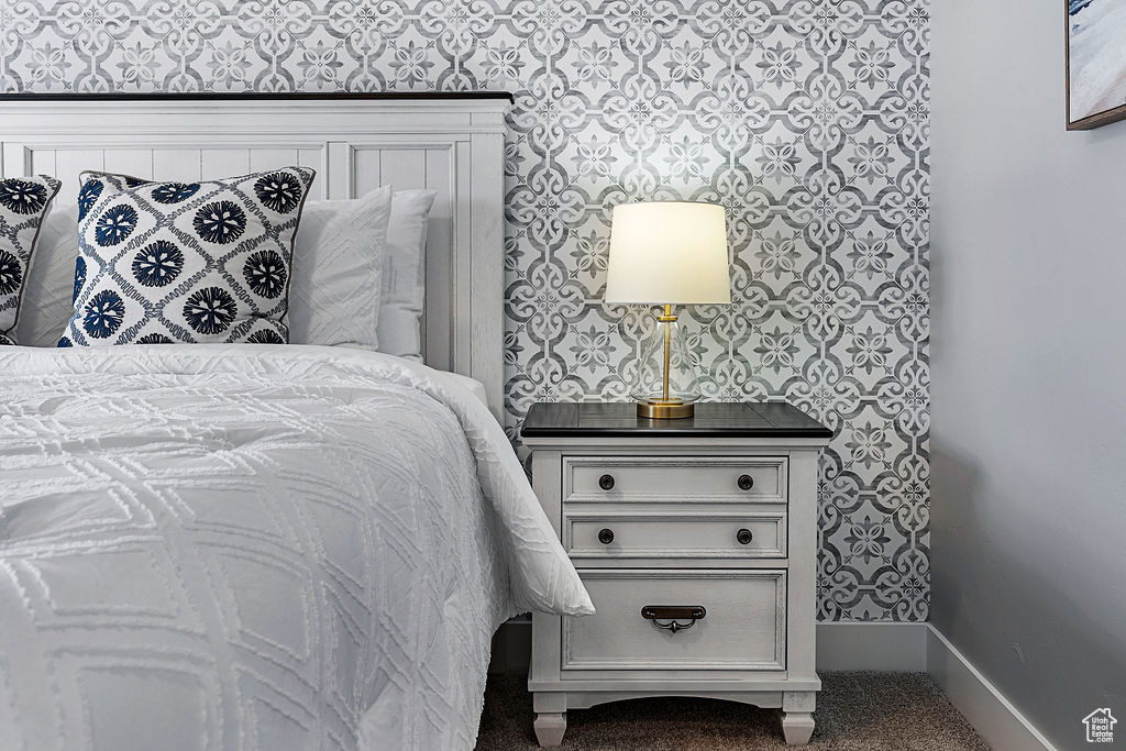 Bedroom with carpet floors and baseboards