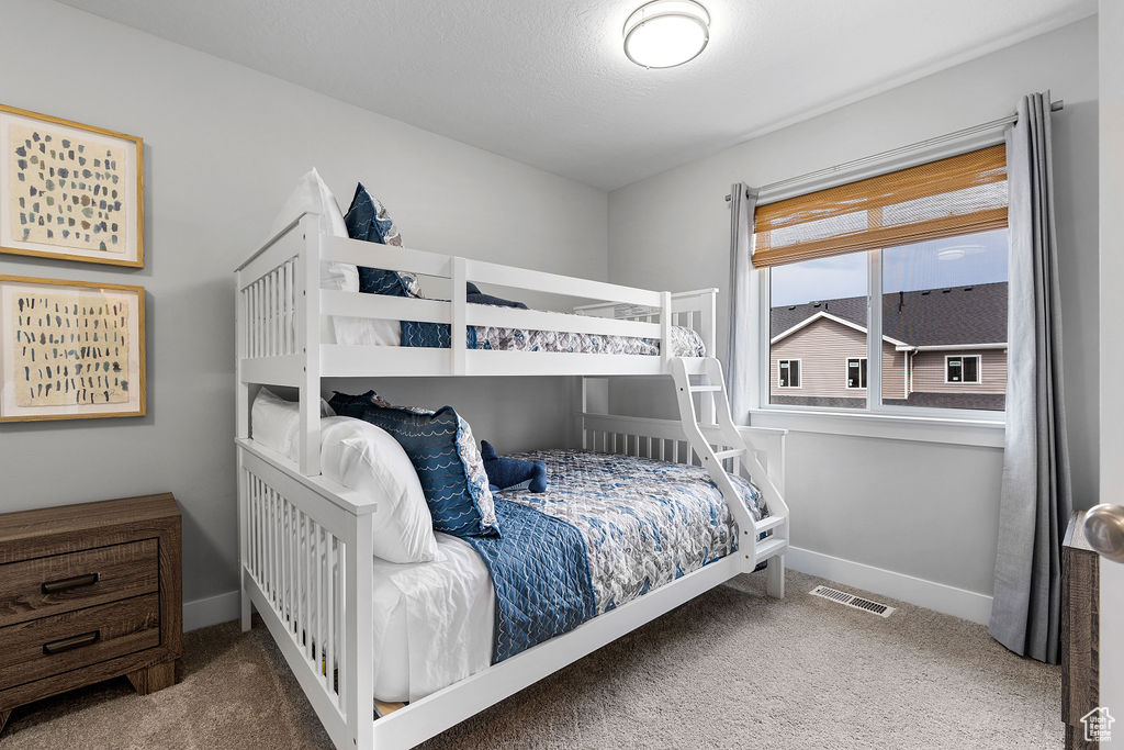 Bedroom with carpet floors and baseboards